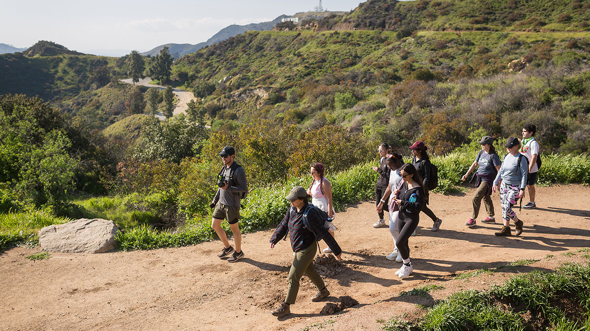 students hiking in Griffith Park with the Hollywood sign in the background