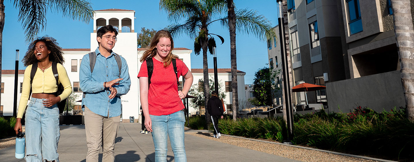 three students walking on campus